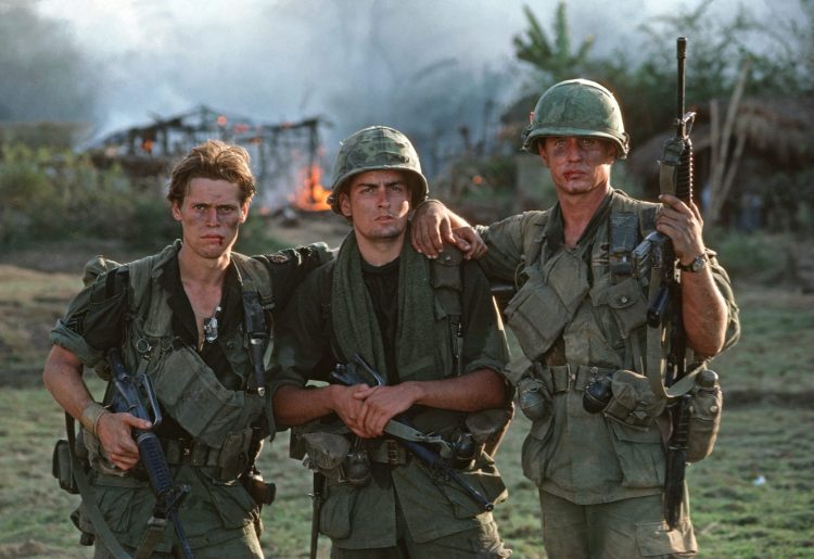 PHILIPPINES - 1986/01/01: During the filming of Oliver Stone's Platoon at a location near Manila, actors Willhem Dafoe, Charlie Sheen and Tom Berenger pose after a key scene in the movie which later became a classic about the Vietnam War.. (Photo by Roland Neveu/LightRocket via Getty Images)