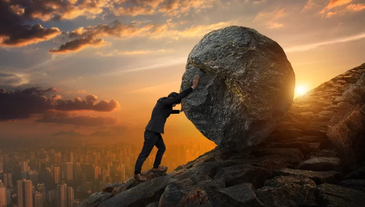 Business man pushing large stone up to hill , Business heavy tasks and problems concept